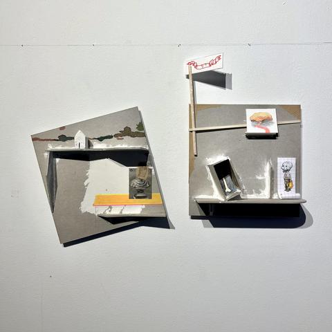 A small construction made of cardboard in two parts, with drawings and photos glued to it, and a flag held with an elastic. There are : a small house, the photo of a bust with a mask sticked to it, a bone, a transparent man wearing a mask, a watercolour of a landscape. Everything looks a little precarious and tilted