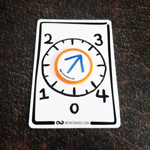 An InfiniTokens dry erase token with a speedometer on it that goes from 0 to 4. An InfinIToken dry erase round counter sits in the center with an arrow drawn on it. The arrow has been spun to 3. 