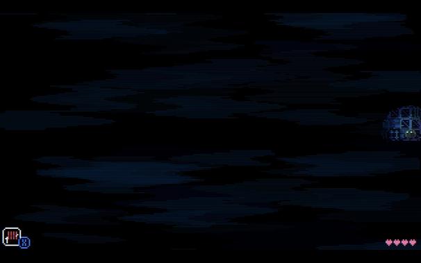 Animal Well screenshot which is almost entirely black apart from a small spot of light on the middle right side where the player's avatar, a small brown blob, sits.