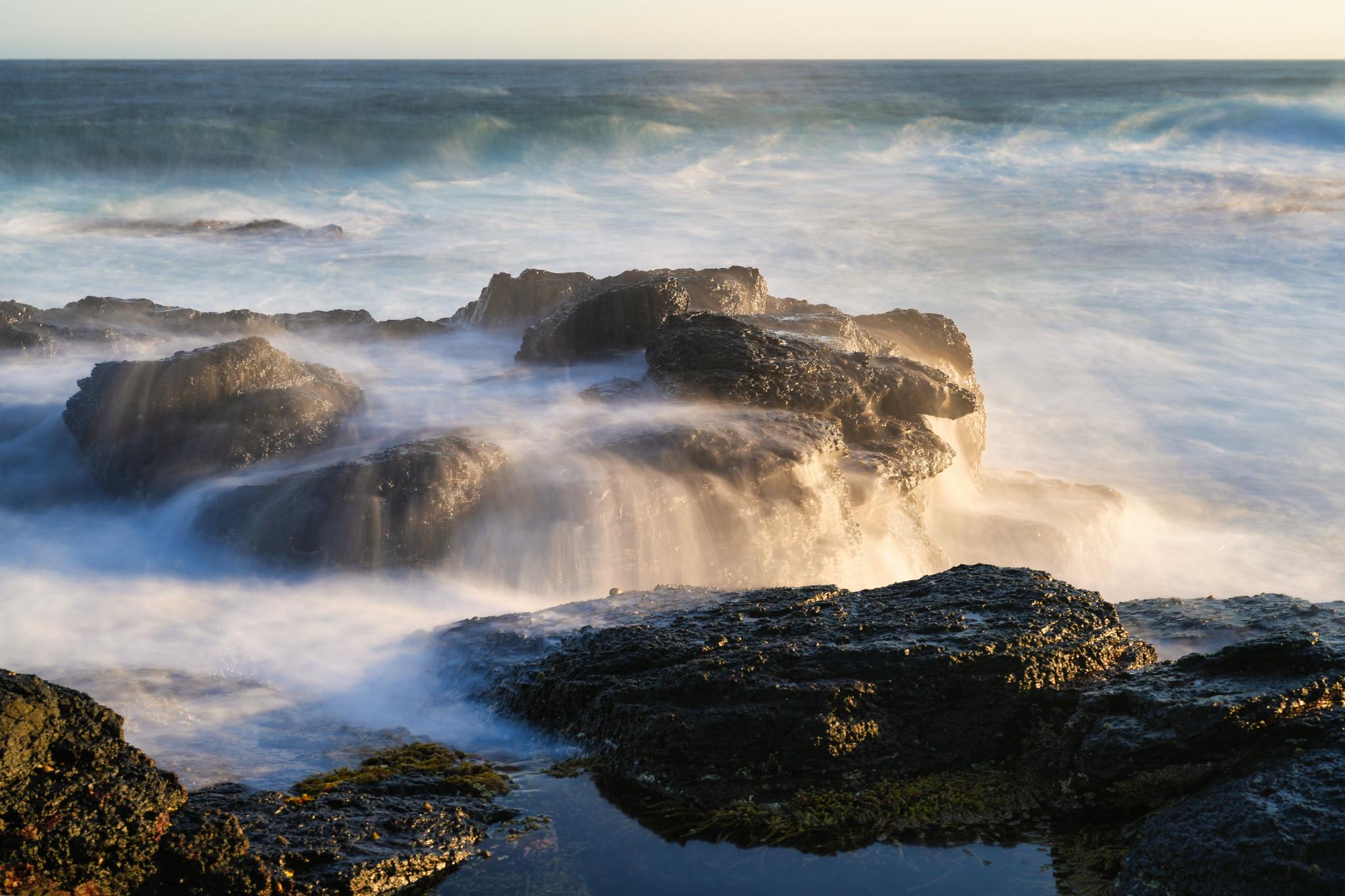 An image where a long exposure shot is taken on the waves coming down on the sea rock like a Mini waterfall at Mornington Peninsula, naarm Melbourne Australia