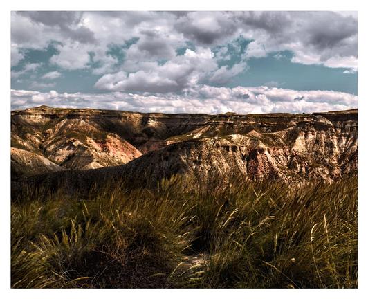 A panoramic view of yellow red colored mountains and canyons 