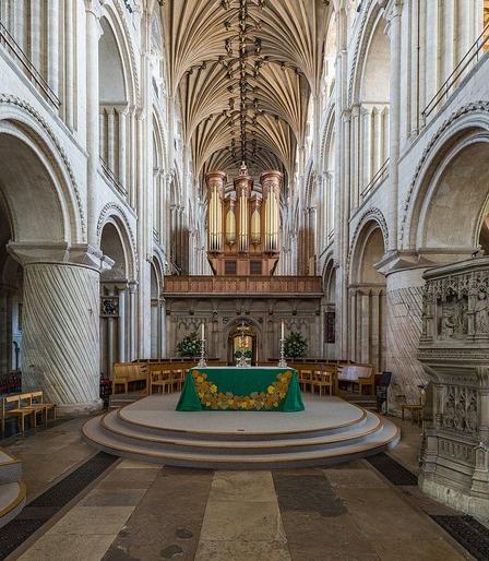 a photo looking at the altar, high arches and walls and columns and ceiling 
