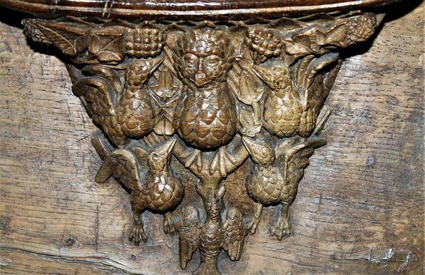 a close-up of a carving, it is like a man made of pinecones 