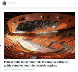 photo d'un post incluant une photo d'un stade couvert avec une piste de cyclisme au centre des sièges orange
