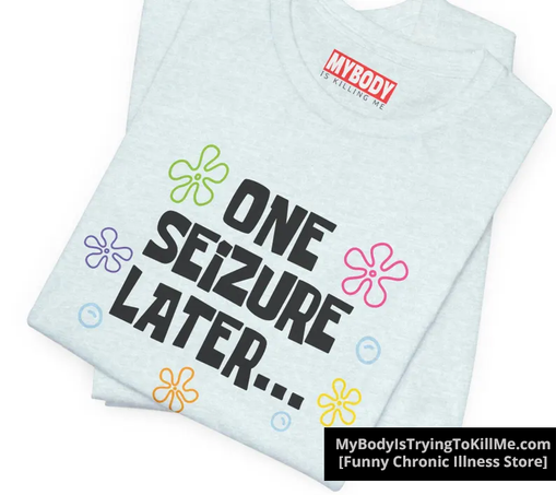 light blue tee that says one seizure later...