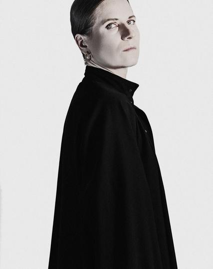 Self-portrait featuring both sides with contrasting black and white clothing and image desaturation,  for black and white photography aesthetic. 