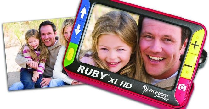 RUBY XL HD portable video magnifier being used to magnify the picture of a family (daughter, dad, and mom.)
