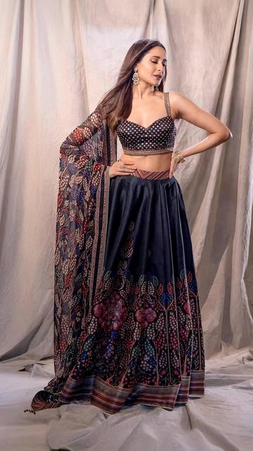 In a stunning midnight blue lehenga adorned with pink, blue, and cream floral prints, Pragya Jaiswal showcases impeccable style. The ensemble's intricate details and her graceful presence make this a standout look.