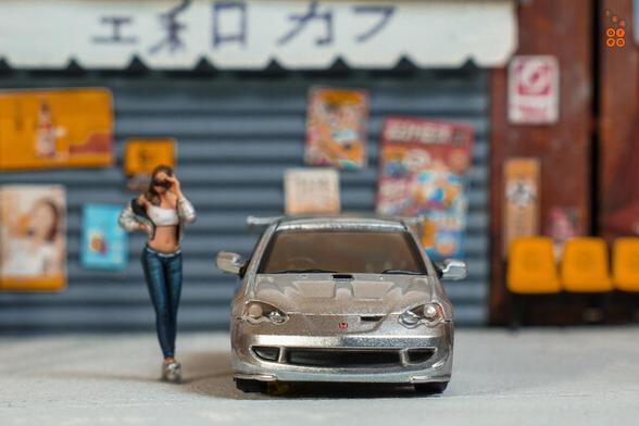 A front side of Honda Integra Type R DC5 Mugen, Silver by Tarmac Works in 1:64 scale with 1:64 figure on AREA 164
