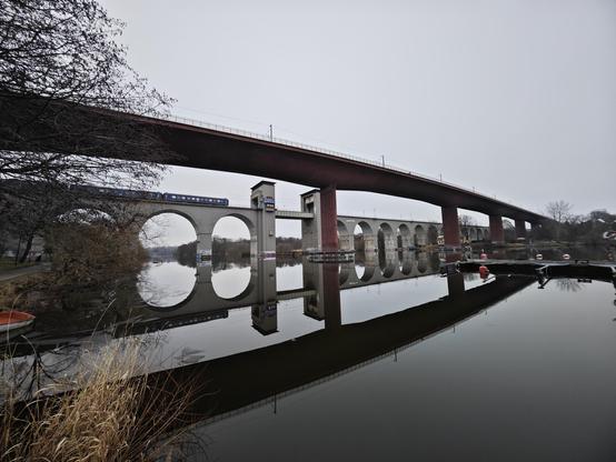 mirrored bridges in glossy water