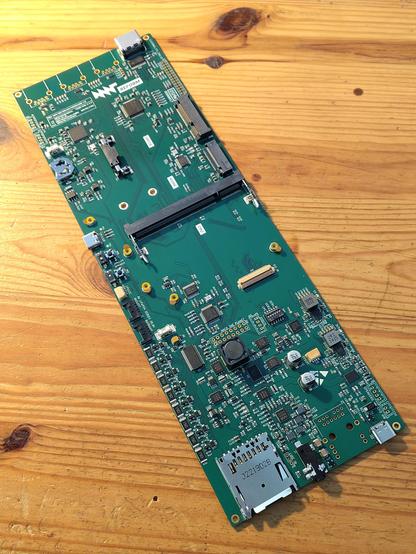 a green self assembled reform 3.0 motherboard on a wooden table