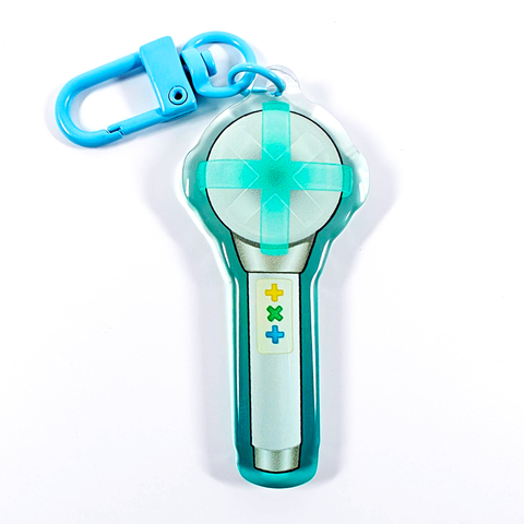 A picture of an acrylic keychain of a drawn version of TXT's newest lightstick. The rim of the keychain has an ombre that goes from teal at the bottom to clear at the top. It has a light blue clasp.