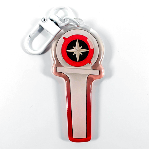 A picture of an acrylic keychain of a drawn version of Stray Kids' newest lightstick. The rim of the keychain has an ombre that goes from red at the bottom to clear at the top. It has a white clasp.