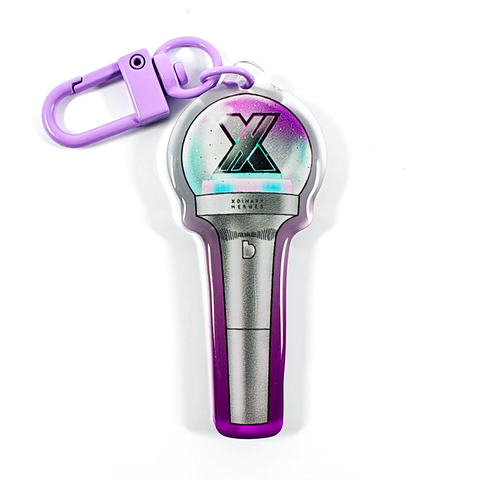 A picture of an acrylic keychain of a drawn version of Xdinary Heroes' newest lightstick. The rim of the keychain has an ombre that goes from purple at the bottom to clear at the top. It has a light purple clasp.