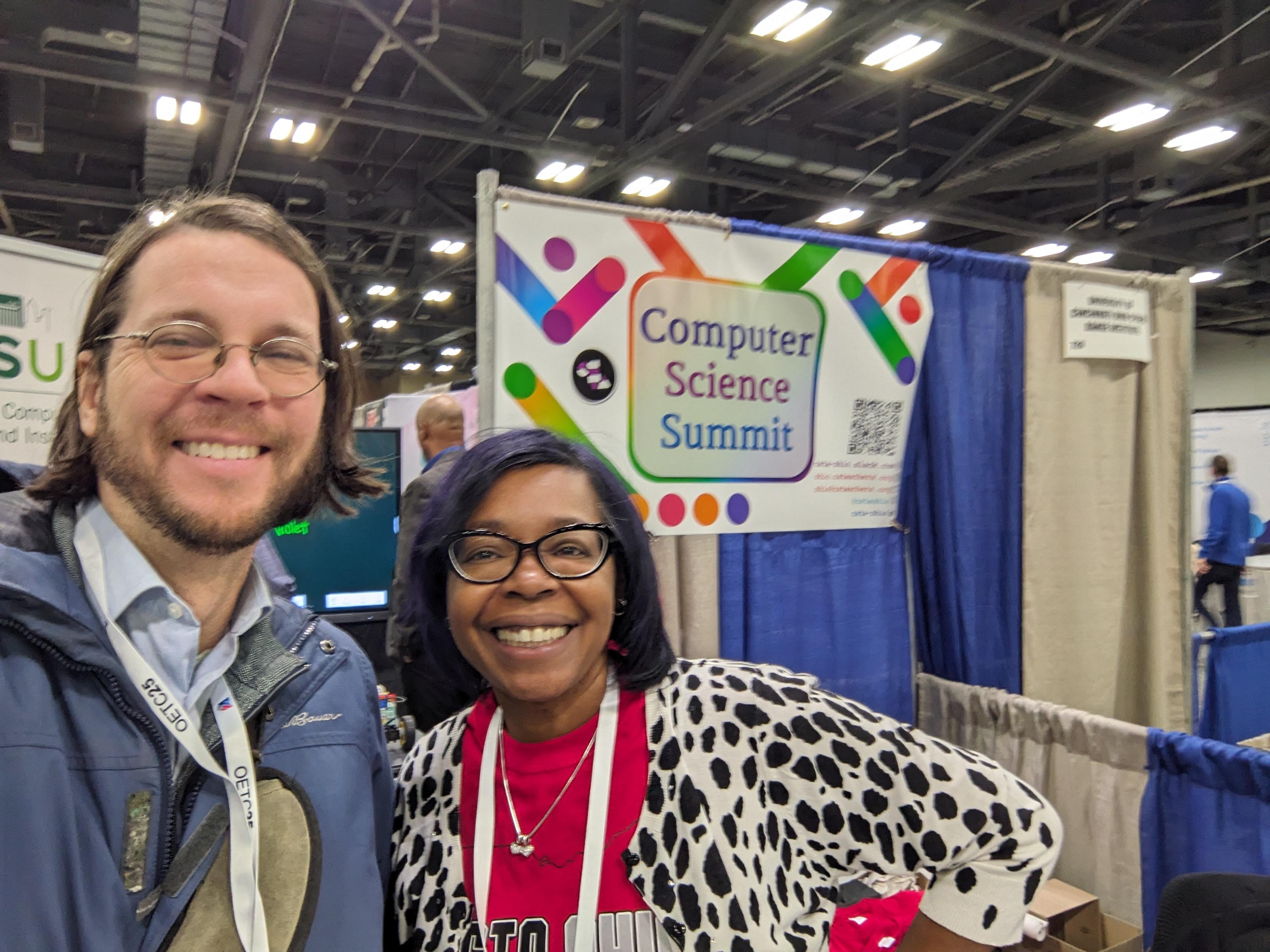 Chris Orban and Crystal Franklin do a selfie in front of a sign for the Ohio CS summit