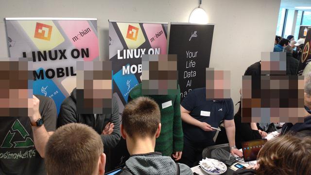 A closer photo of the stand with the attendees talking across the table to all the many people running the stands.