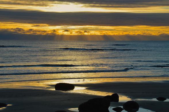 Golden Rays

Last sunrise of 2023 at Wells Beach, Maine. After the sun had risen above the horizon, it quickly climbed behind some clouds that moved in. The golden colors and rays of light came bursting through those clouds.