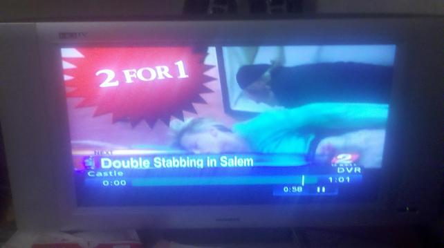 Fuzzy shot of a TV screen from 2010. At the bottom, a blue 11 o'clock news banner for a Portland, Oregon station over a promo for the next episode of the series "Castle." The banner reads, "Double Stabbing in Salem." The episode promo shows two bodies apparently having just tumbled out of a casket. A large, red, spiky bubble reads "2 for 1." 