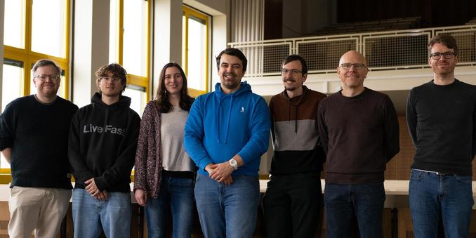 Seven smiling people in a lecture hall
(left to right) Ben Hermann, Julius Näumann, Anemone Kampkötter, Johannes Düsing, Dominik Helm, Michael Eichberg, Tobias Roth