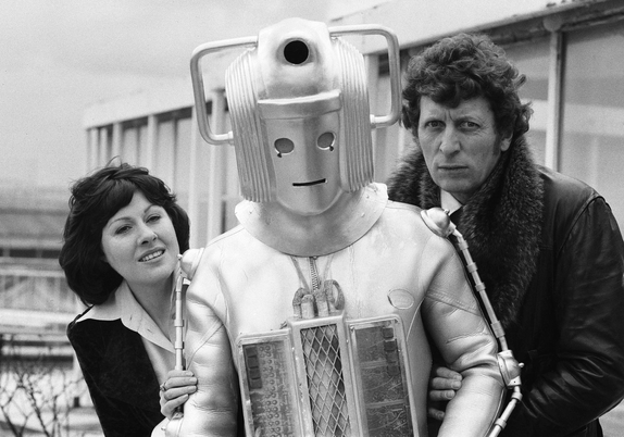 Friday, 15th February, 1974: Elisabeth Sladen and a slightly shabby Cyberman join Tom Baker on the patio outside the BBC Television Centre restaurant as the new Doctor is introduced to the press.