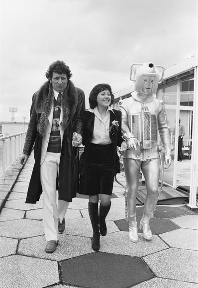 Friday, 15th February, 1974: Tom Baker and Elisabeth Sladen take a stroll with a Cyberman outside the BBC Television Centre restaurant as the new Doctor is introduced to the press.