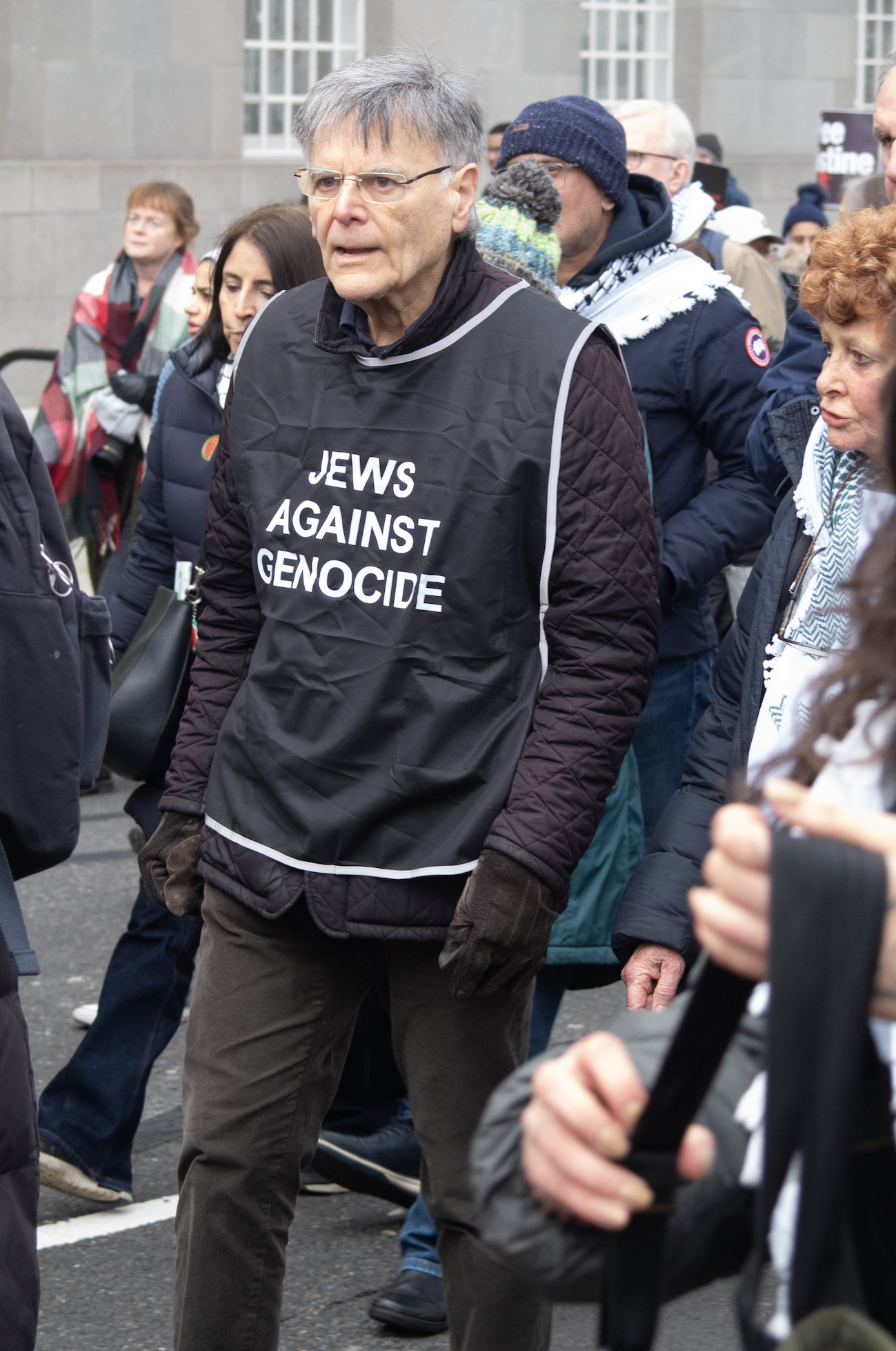 old man dressed in black with a tabard 'Jews against genocide'