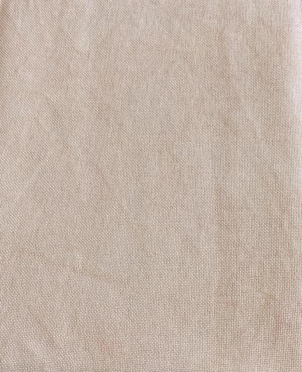 A very light tan piece of fabric with a slight pink undertone