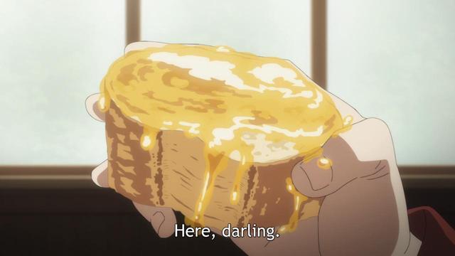 A piece of what appears to be bread covered in a yellow syrup with a subtitle saying, “Here, darling.”