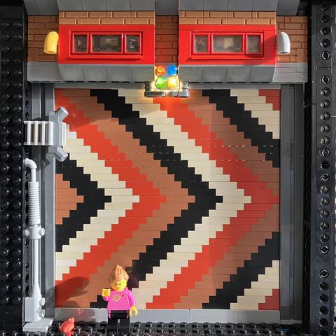 Chevron pattern made in a wall with LEGO Modulex bricks. 