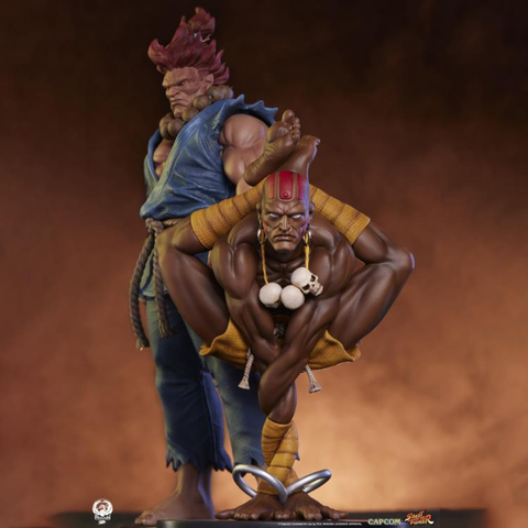 a photo of dhalsim in front of akuma, he is facing the viewer, in one of his yoga positions where his hands are on the ground and his legs wrapped behind him, the background is a dusty cloudy tan color 