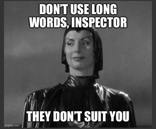 A black and white image of a woman in a shiny, tight-fitting outfit, smiling confidently. Text at the top reads "DON'T USE LONG WORDS, INSPECTOR" and at the bottom, "THEY DON'T SUIT YOU."