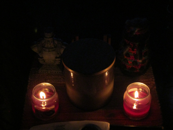 Image of a Duke Nukem bust and a knitted dalek with a couple of lit candles