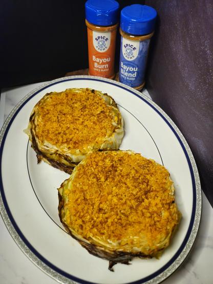 Cabbage cut into 1" steak rounds, then brushed with olive oil, lemon juice, and Spice Krewe spice blends, then roasted at 400 degrees for 15 minutes, then topped with breadcrumbs, cheese, lemon zest, and Spice Krewe spice blends, then roasted for another 10-15 minutes, until topping is a golden brown color. Serve warm.
