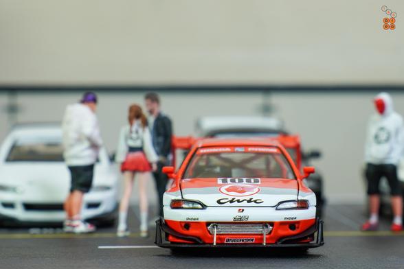 A front side of Honda Civic EG6, Pandem, Idemitsu livery, All In Tuning 2024 Edition by Pop Race in 1:64 scale with 1:64 figure on AREA 164