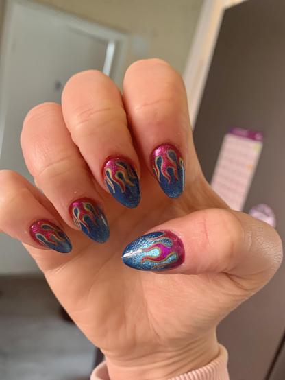 Hand clenched with nails pointing in towards palm, they are decorated with teal background, and pink flames, with a green outline.