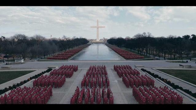 Scene from The Handmaid's Take on #Netflix: "Here is an alt-text description for the image: A high-angle shot shows a large gathering of people dressed in red robes and white bonnets, arranged in rows on a concrete plaza. In the distance, a large white cross stands prominently on a reflecting pool. Bare trees line the sides of the pool. The sky is overcast with some clouds. Provided by @altbot, generated using Gemini"
In archive: /media_attachments/files/114/001/260/182/925/542/original/efb41a624d86b45f.jpg