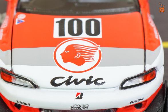 A close-up shot of Honda Civic EG6, Pandem, Idemitsu livery, All In Tuning 2024 Edition by Pop Race in 1:64 scale with 1:64 figure on AREA 164