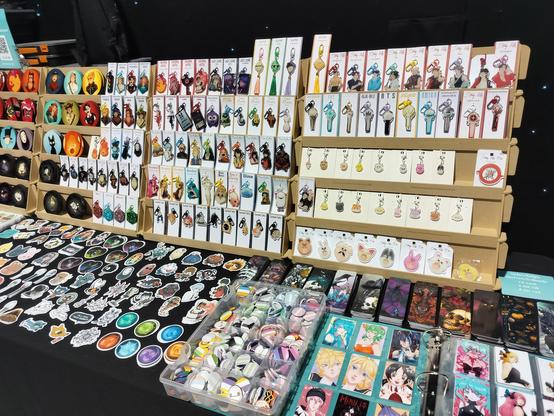 A close-up of the right side of the table where you can see keychains, coasters, stickers, bookmarks and mini prints more closely.
