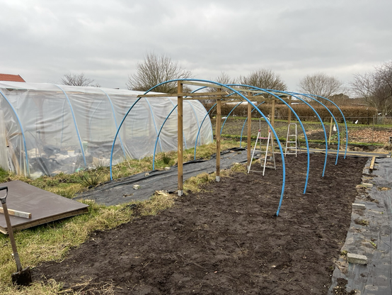 Framing for the plastic tunnel with water pipes
