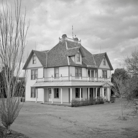 A black and white film photo. The Barton House sits elegantly at the National Ranching Heritage Center in Lubbock, Texas. Saturday, February 15, 2025.