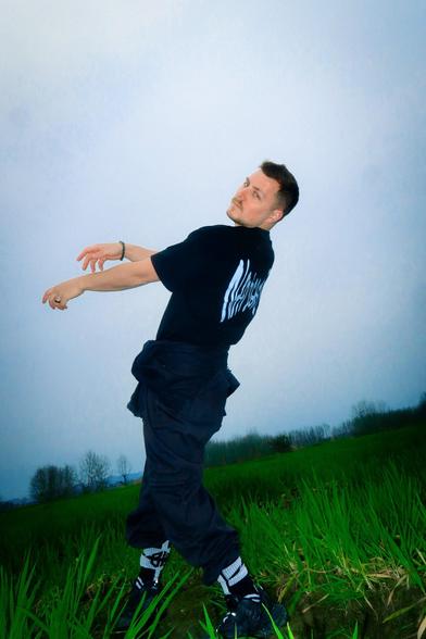 Nuño de la Serna striking a pose outdoors in a field, with a bright sky and greenery, during a photoshoot in Sichuan, China