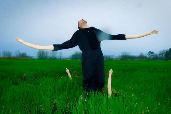 Nuño de la Serna standing outdoors with arms outstretched towards the sky, during a photoshoot in Sichuan, China