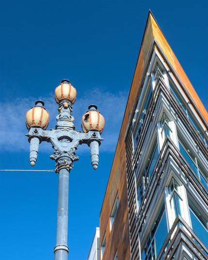 An old-fashioned lamppost juxtaposed against a modernist building