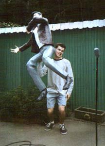 Robert Cockerham holding his Elvis Presley statue over his shoulder in his backyard.