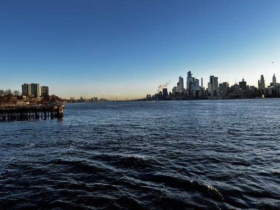 The Hudson River, looking upstream, features cold water, churned by a ferry. In the distance the smile of the George Washington Bridge. On the left, a pier, and past it, Stevens Institute of Technology. On the right, Manhattan's Hudson Yards represents a vision of the future that would have impressed a 1950s science fiction fan, but leaves the denizen of the 21st century cold.