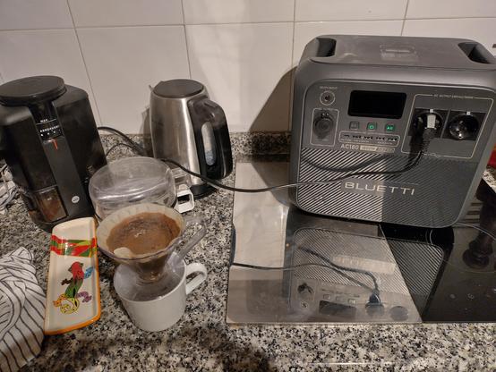 My electric kettle, coffee grinder, a Bluetti brand portable battery power system and my filter coffee brewing in my kitchen.
