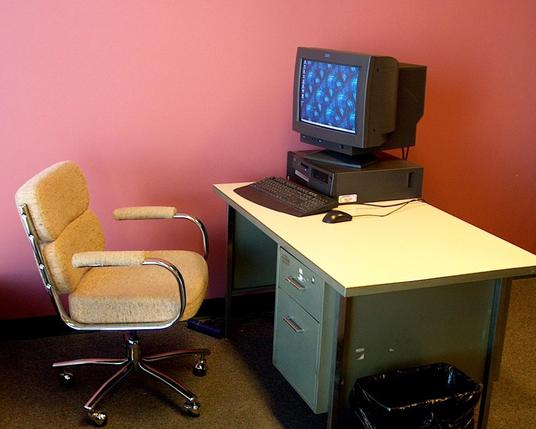 Computer on desk, with chair