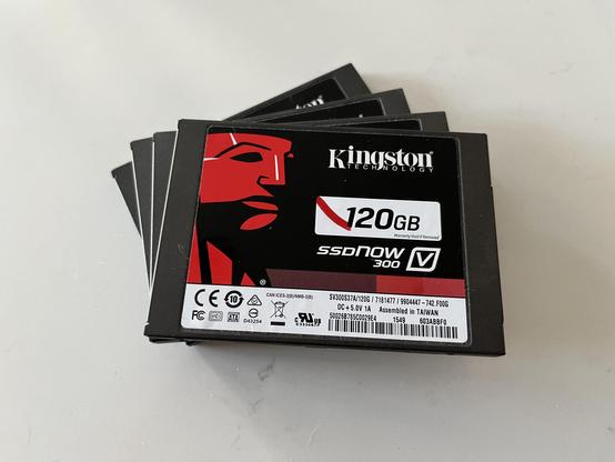 A photo of a stack of four 2.5” SSD drives with Kingston’s iconic black and red label. 