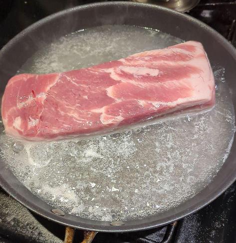 Pork belly in a pan if boiling water