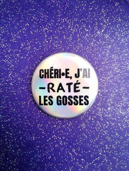 Badge sur fond pailleté sur lequel est écrit "chéri j'ai raté les gosses"